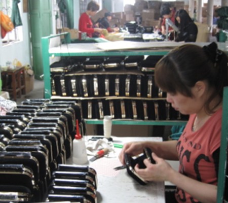 quality control-a worker is checking clutch bag quality control-a worker is checking clutch bag
