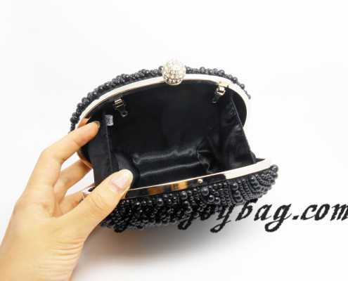 Ladies' black bead pearl oval metal frame clutch - lining view